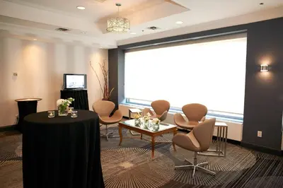 a meeting room with chairs and a table and a large window at Courtyard by Marriott Toronto Downtown in Toronto