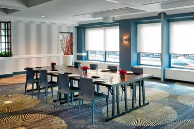 a conference room with a long table and chairs at Courtyard by Marriott Toronto Downtown in Toronto
