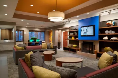 a large living room with couches and a fireplace at Courtyard by Marriott Toronto Downtown in Toronto