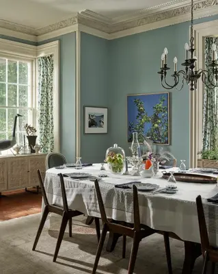a dining room with a white table and chairs at The Eddie Hotel and Farm in Bloomfield