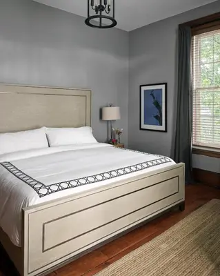 a bedroom with a large white bed in a room at The Eddie Hotel and Farm in Bloomfield