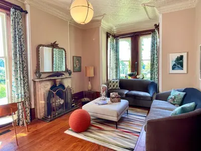 a living room with a couch and a fireplace at The Eddie Hotel and Farm in Bloomfield