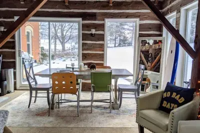 a dining room with a table and chairs at A charming, rustic 150 year old Carriage House in Orangeville