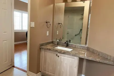 a bathroom with a sink and a large mirror at Aurora Executive Upscale Residence Three Bedrooms Three and Half Bathrooms in Aurora