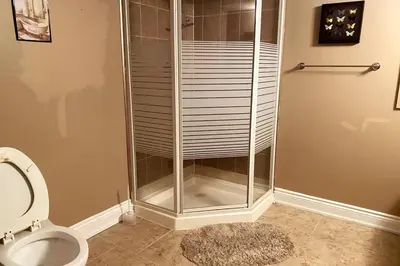 a shower stall in a bathroom with a toilet at Aurora Executive Upscale Residence Three Bedrooms Three and Half Bathrooms in Aurora