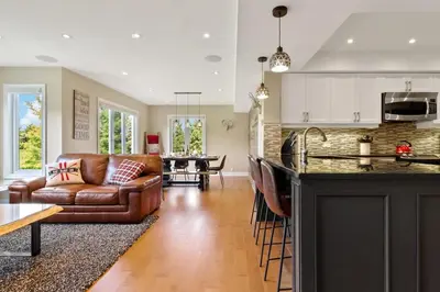 a kitchen and living room with a couch and a table at Luxurious Sierra Lane Escape in Blue Mountains