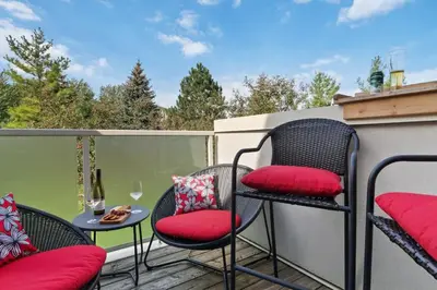 a patio with chairs and a table on a balcony at Luxurious Sierra Lane Escape in Blue Mountains