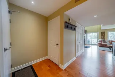 an empty living room with a door and wood floors at Luxurious Sierra Lane Escape in Blue Mountains
