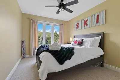 a bedroom with a bed with a ceiling fan at Luxurious Sierra Lane Escape in Blue Mountains