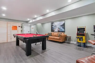a room with a pool table and a couch at Modern home with a pool sauna pooltable & mountain view in Collingwood
