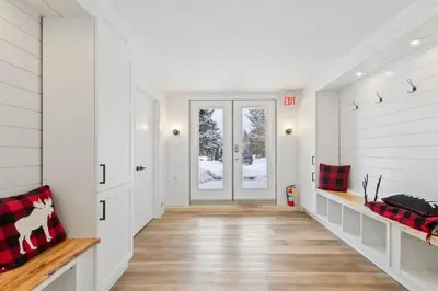 a hallway of a home with white walls and wood floors at Paradise Manor w Hot tub Sauna & Putting Green in Blue Mountains