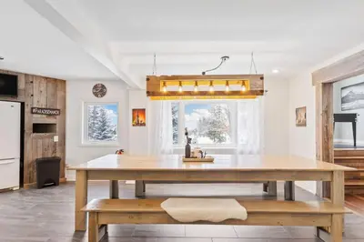 a kitchen with a large wooden table in a room at Paradise Manor w Hot tub Sauna & Putting Green in Blue Mountains