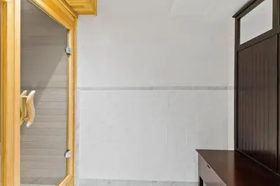 a bathroom with a shower with white tiles at Paradise Manor w Hot tub Sauna & Putting Green in Blue Mountains