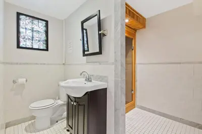 a bathroom with a sink and a toilet at Paradise Manor w Hot tub Sauna & Putting Green in Blue Mountains