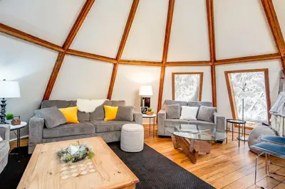 a living room with two couches and a table at The Beehive w Hot Tub Sauna & Fireplace in Blue Mountains