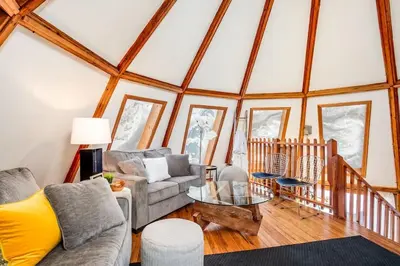a living room with a couch and a table at The Beehive w Hot Tub Sauna & Fireplace in Blue Mountains