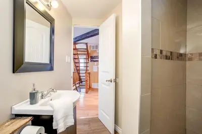 a bathroom with a sink and a shower at The Beehive w Hot Tub Sauna & Fireplace in Blue Mountains