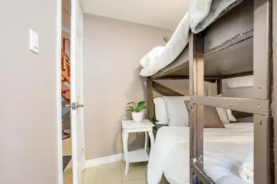 a bedroom with two bunk beds and a plant at The Beehive w Hot Tub Sauna & Fireplace in Blue Mountains