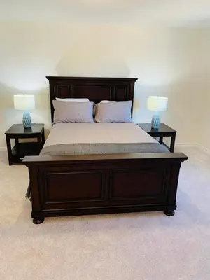 a bedroom with a large bed with two end tables at Close Property in Bowmanville