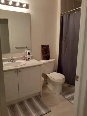 a bathroom with a sink and a toilet and a shower at Close Property in Bowmanville