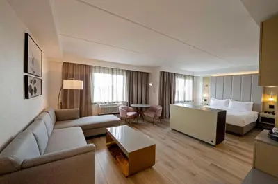 a hotel room with a bed and a living room at Bloom Mississauga, Tapestry Collection By Hilton in Mississauga