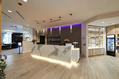 a store lobby with a marble counter and purple lighting at Bloom Mississauga, Tapestry Collection By Hilton in Mississauga