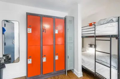 a room with two bunk beds and a mirror at Samesun Toronto in Toronto