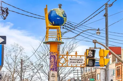 a yellow pole with a globe on top of it at Samesun Toronto in Toronto