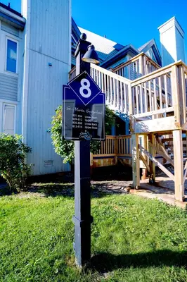 a street sign in the grass in front of a house at Hillside BLUE MTN Family Loft @ North Creek Resort in Blue Mountains