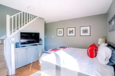 a bedroom with a bed with a red backpack on it at Hillside BLUE MTN Family Loft @ North Creek Resort in Blue Mountains