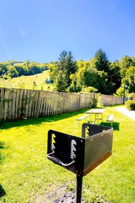 a bench in a yard with two picnic tables at Updated Blue Mountain Studio @ North Creek Resort in Blue Mountains