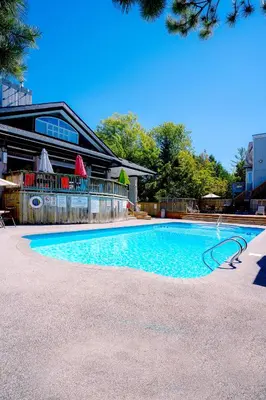 a swimming pool in front of a building at Updated Blue Mountain Studio @ North Creek Resort in Blue Mountains