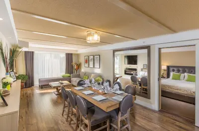 a dining room and living room with a table and chairs at Living Water Resort & Spa in Collingwood