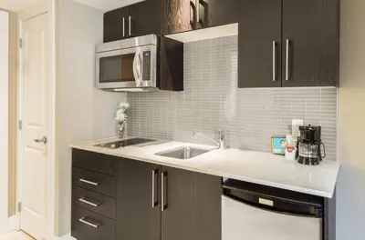 a kitchen with a sink and a microwave at Living Water Resort & Spa in Collingwood