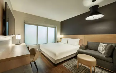 a hotel room with a bed and a couch at Hyatt Place Toronto-Brampton in Brampton