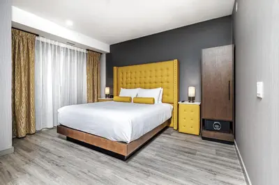 a bedroom with a large bed and a yellow headboard at Hyatt Place Toronto-Brampton in Brampton
