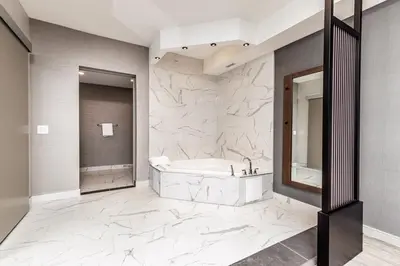 a white bathroom with a tub and a shower at Hyatt Place Toronto-Brampton in Brampton