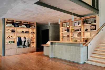 a shop with a staircase in a room with shelves at Ace Hotel Toronto in Toronto