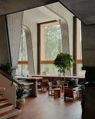 a large room with tables and chairs and windows at Ace Hotel Toronto in Toronto