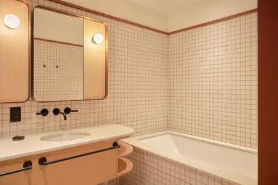 a bathroom with a sink and a bath tub at Ace Hotel Toronto in Toronto