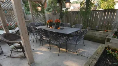 a patio with a table and chairs and a fence at Bristows Inn in Elmira