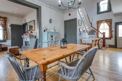 a dining room with a wooden table and chairs at Bristows Inn in Elmira