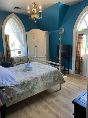 a bedroom with a bed with a stuffed animal on it at Bristows Inn in Elmira