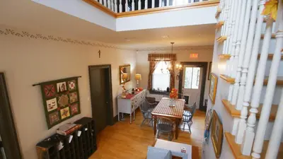 a dining room and living room with a table and chairs at Bristows Inn in Elmira