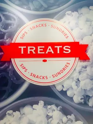 a container of popcorn with a red ribbon saying treats at Hampton Inn by Hilton Port Hope Cobourg in Port Hope