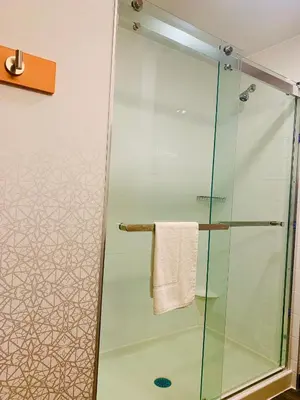 a shower with a glass door in a bathroom at Hampton Inn by Hilton Port Hope Cobourg in Port Hope