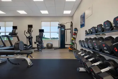 a gym with lots of treadmills and weights at Hampton Inn by Hilton Port Hope Cobourg in Port Hope