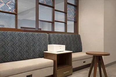 a waiting room with a couch and a table at Hampton Inn by Hilton Port Hope Cobourg in Port Hope