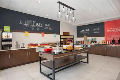 a fast food restaurant with a counter with food at Hampton Inn by Hilton Port Hope Cobourg in Port Hope