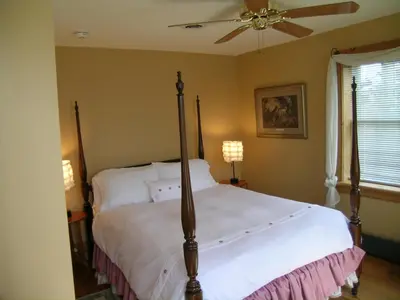 a bedroom with a bed and a ceiling fan at Emilyville Inn in Campbellford